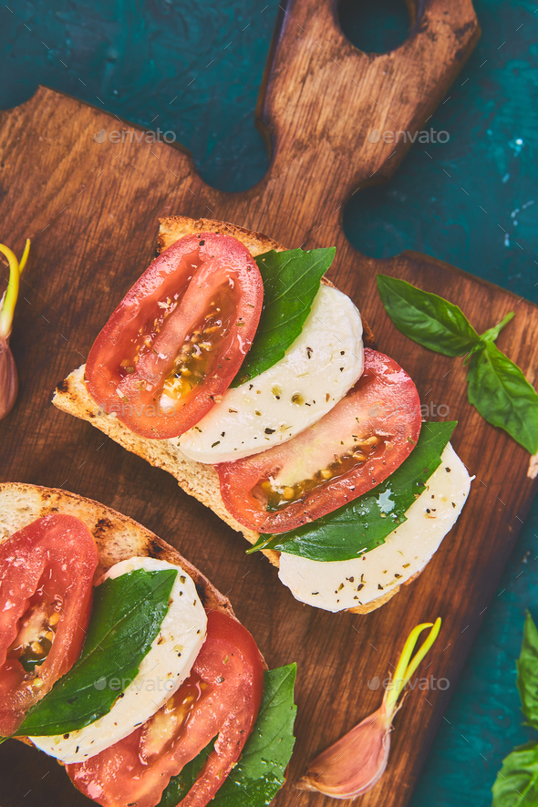 Bruschetta with tomatoes, mozzarella cheese and basil - Stock Photo - Images