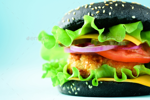 Delicious burger with beef, cheese, lettuce, onion, tomatoes on yellow background. Close up banner - Stock Photo - Images