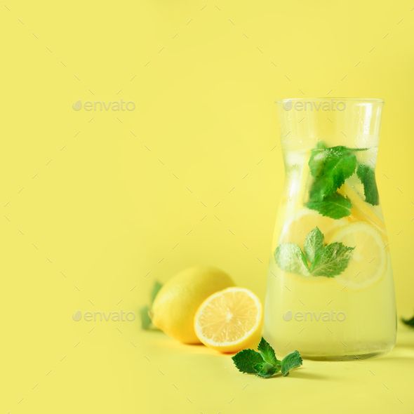 Citrus lemonade - mint, lemon and tropical monstera leaves on yellow background. Square crop. Detox - Stock Photo - Images
