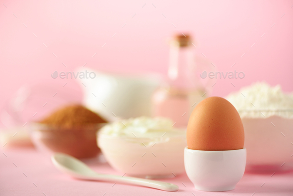 White cooking utensils on pink background. Food ingredients. Macro of egg. Cooking cakes and baking - Stock Photo - Images