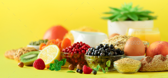 Organic food frame. Banner. Healthy breakfast ingredients. Oat and corn flakes, eggs, nuts, fruits - Stock Photo - Images