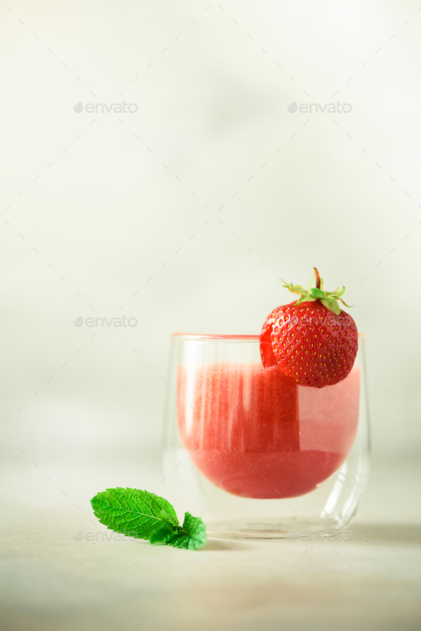 Glass with vegan strawberry smoothie on grey background with copy space. Summer food and clean - Stock Photo - Images