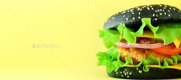 Fast food concept. Square crop. Juicy homemade hamburgers on yellow background. Take away meal - Stock Photo - Images