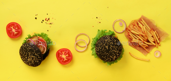 Fast food banner. Juicy meat burgers with beef, tomato, cheese, onion, cucumber and lettuce on - Stock Photo - Images