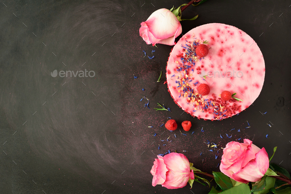 Pink roses and delicious raspberry cake with fresh berries, rosemary, dry flowers on dark vintage - Stock Photo - Images