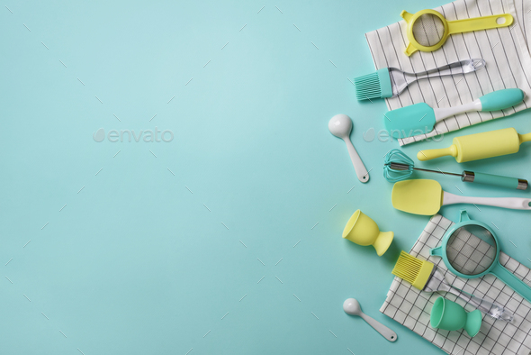 Pastel yellow, blue cooking utensils on turquoise background. Food ingredients. Cooking cakes and - Stock Photo - Images