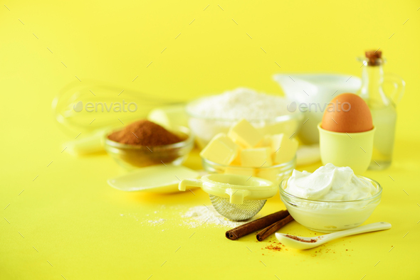 Holiday bakery background. Food frame - butter, sugar, flour, milk, eggs, oil, spoon, rolling pin - Stock Photo - Images