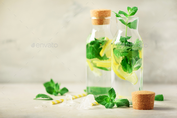 Citrus lemonade - mint, lemon and tropical monstera leaves on grey background. Detox drink. Summer - Stock Photo - Images