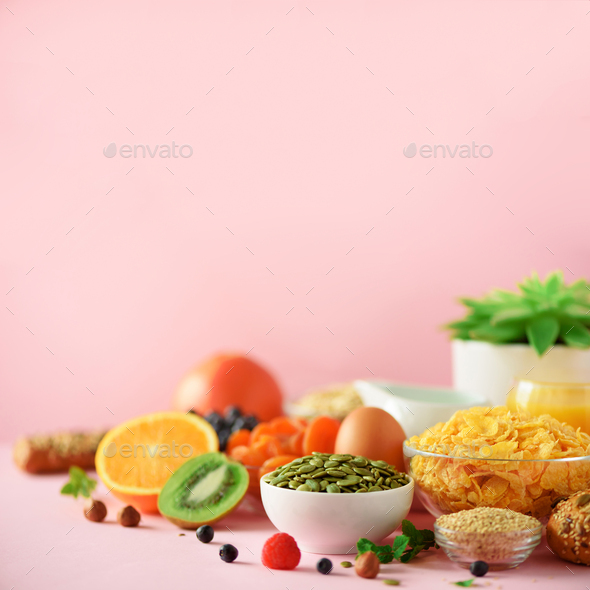 Healthy breakfast ingredients. Square crop. Oat and corn flakes, eggs, nuts, fruits, berries, toast - Stock Photo - Images