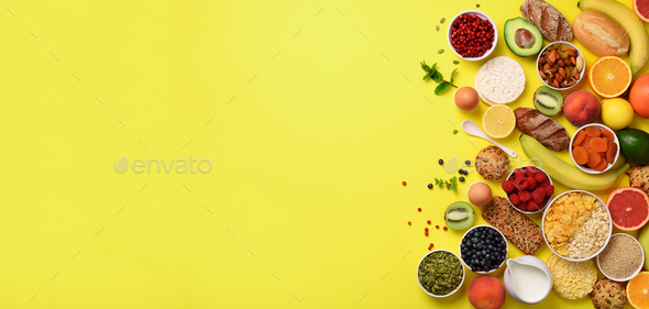 Organic food frame. Banner. Healthy breakfast ingredients. Oat and corn flakes, eggs, nuts, fruits - Stock Photo - Images