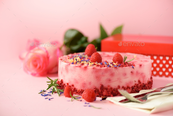 Gift boxes, roses, raspberry cake with fresh berries, rosemary and dry  flowers on pink background Stock Photo by jchizhe