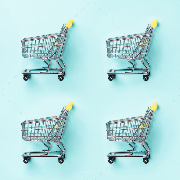 Shopping cart on blue background. Minimalism style. Creative design. Top view with copy space. Shop - Stock Photo - Images
