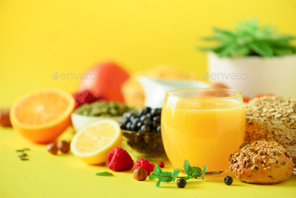 Orange juice, fresh berries, milk, yogurt, boiled egg, nuts, fruits, banana, peach for breakfast on - Stock Photo - Images