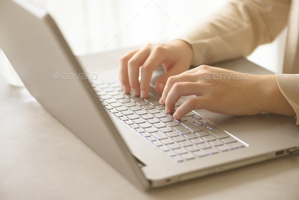 Close-up of hands typing on laptop keyboard at the office. Copy space. Worker, business, remote work - Stock Photo - Images
