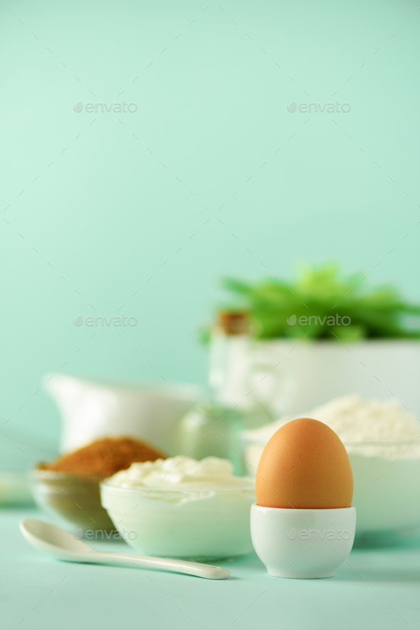 Time to bake. Baking ingredients - butter, sugar, flour, eggs, oil, spoon, brush, whisk, milk over - Stock Photo - Images