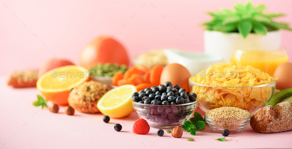 Vegetarian breakfast. Soft boiled egg, oat flakes, nuts, fruits, berries, milk, yogurt, orange - Stock Photo - Images