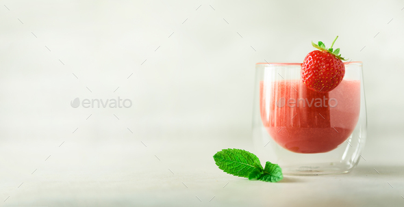 Berry smoothie in glass on gray background with copy space. Summer food and clean eating concept - Stock Photo - Images