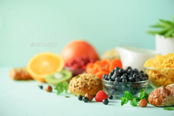 Vegetarian breakfast. Soft boiled egg, oat flakes, nuts, fruits, berries, milk, yogurt, orange - Stock Photo - Images