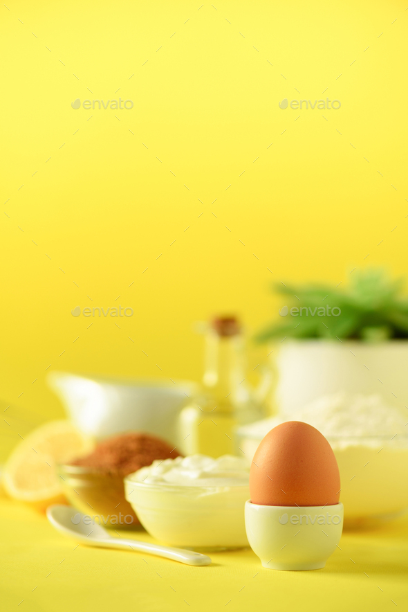White cooking utensils on yellow background. Food ingredients. Macro of egg. Cooking cakes and - Stock Photo - Images