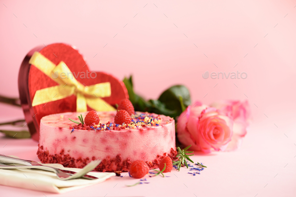 Gift boxes in shape of heart, roses, raspberry cake with fresh berries, rosemary and dry flowers on - Stock Photo - Images