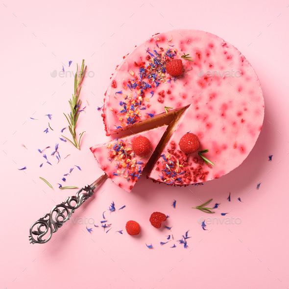 Delicious raspberry cake with fresh berries, rosemary and dry flowers on pink background. Copy space - Stock Photo - Images