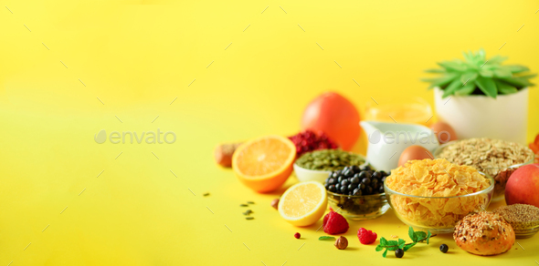 Vegetarian breakfast. Soft boiled egg, oat flakes, nuts, fruits, berries, milk, yogurt, orange - Stock Photo - Images