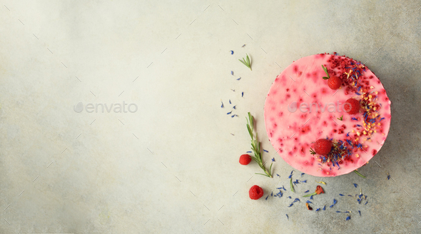 Delicious raspberry cake with fresh berries, rosemary and dry flowers on gray concrete background - Stock Photo - Images