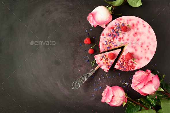 Pink roses and delicious raspberry cake with fresh berries, rosemary, dry flowers on dark vintage - Stock Photo - Images