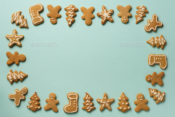 Frame of Christmas gingerbread cookies on blue background with copy space. Pattern of gingerbread - Stock Photo - Images
