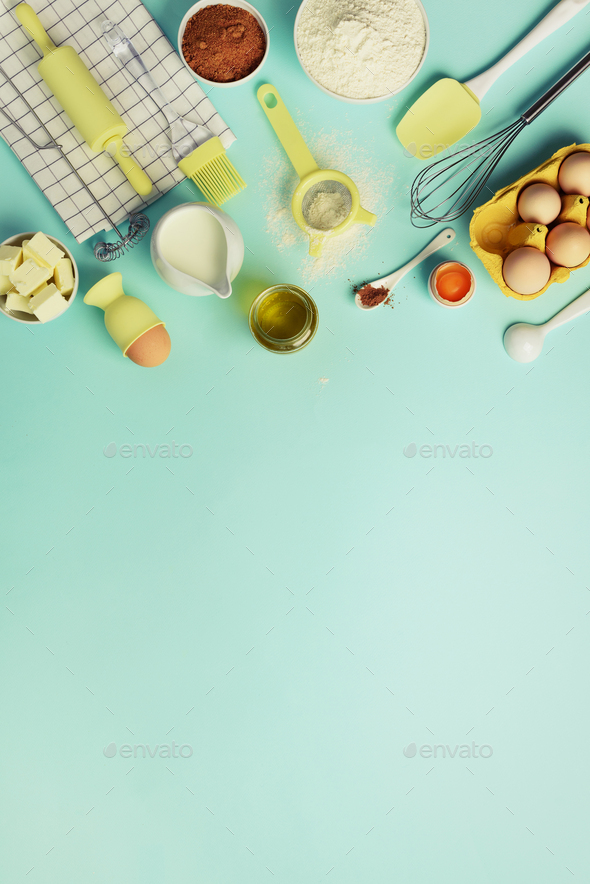 Baking ingredients - butter, sugar, flour, eggs, oil, spoon, rolling pin, brush, whisk, towel over - Stock Photo - Images