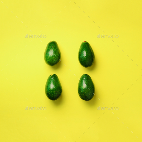 Green avocado pattern on yellow background. Square crop. Top view. Pop art design, creative summer - Stock Photo - Images