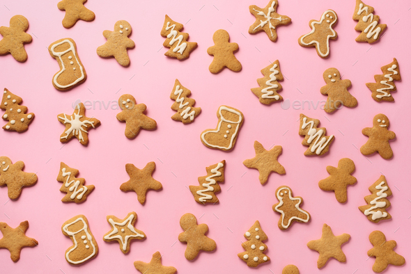 Christmas handmade cookies on pink background. Pattern of gingerbread men, snowflake, star, fir-tree - Stock Photo - Images