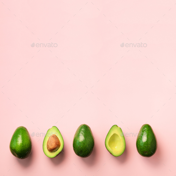 Organic avocado with seed, avocado halves and whole fruits on pink background. Top view. Square crop - Stock Photo - Images