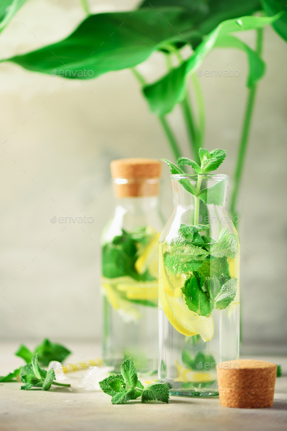 Citrus lemonade - mint, lemon and tropical monstera leaves on grey background. Detox drink. Summer - Stock Photo - Images