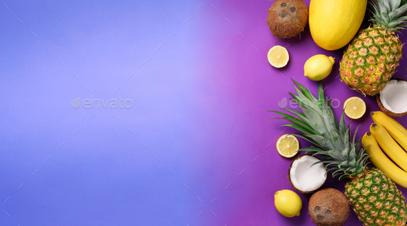 Exotic pineapples, coconuts, banana, melon, lemon, tropical palm and green monstera leaves on purple - Stock Photo - Images