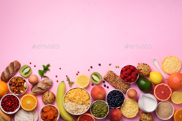 Healthy breakfast ingredients, food frame. Oat and corn flakes, eggs, nuts, fruits, berries, toast - Stock Photo - Images