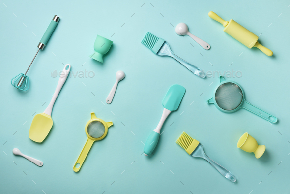 Pastel yellow, blue cooking utensils on turquoise background. Food ingredients. Cooking cakes and - Stock Photo - Images