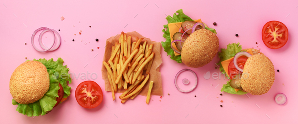Fast food banner. Juicy meat burgers with beef, tomato, cheese, onion, cucumber and lettuce on pink - Stock Photo - Images