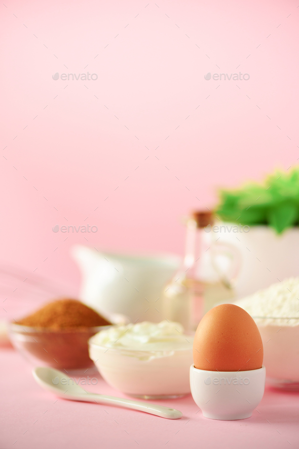 White cooking utensils on pink background. Food ingredients. Macro of egg. Cooking cakes and baking - Stock Photo - Images