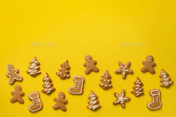 Christmas handmade cookies on yellow background with copy space. Pattern of gingerbread men - Stock Photo - Images