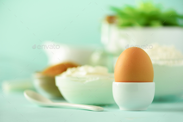 White cooking utensils on blue background. Food ingredients. Macro of egg. Cooking cakes and baking - Stock Photo - Images