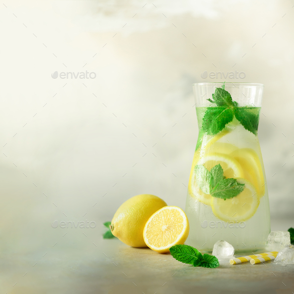 Citrus lemonade - mint, lemon and tropical monstera leaves on grey background. Square crop. Detox - Stock Photo - Images