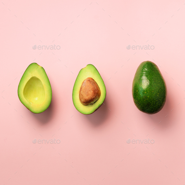 Organic avocado with seed, avocado halves and whole fruits on pink background. Top view. Square crop - Stock Photo - Images