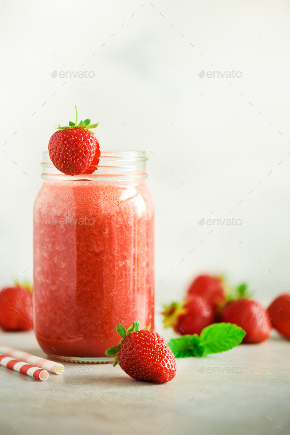 Bottle with vegan strawberry smoothie on grey background with copy space. Summer food and clean - Stock Photo - Images