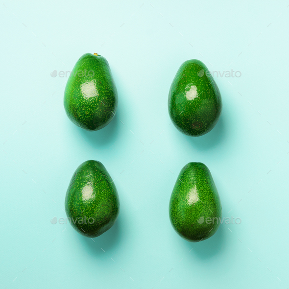 Green avocado pattern on blue background. Top view. Pop art design, creative summer food concept - Stock Photo - Images