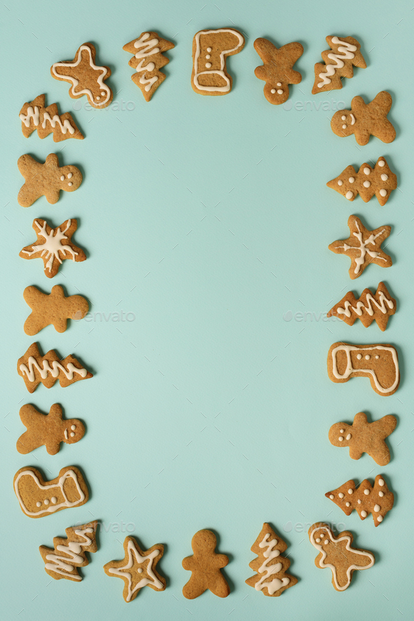Frame of Christmas gingerbread cookies on blue background with copy space. Pattern of gingerbread - Stock Photo - Images