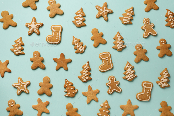 Homemade christmas cookies on blue background. Pattern of gingerbread men, snowflake, star, fir-tree - Stock Photo - Images