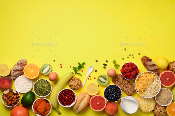 Healthy breakfast ingredients, food frame. Oat and corn flakes, eggs, nuts, fruits, berries, toast - Stock Photo - Images