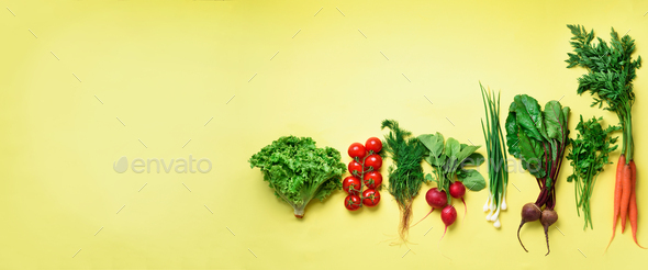 Organic vegetables on yellow background with copy space. Banner. Top view of carrot, beet, pepper - Stock Photo - Images