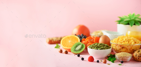 Organic food frame. Banner. Healthy breakfast ingredients. Oat and corn flakes, eggs, nuts, fruits - Stock Photo - Images